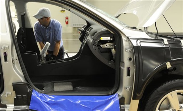 Ben Edwards makes adjustments to the door frame of a Passat in Chattanooga, Tennessee. Edwards is a new employee at the Volkswagen plant which opened on May 24.
